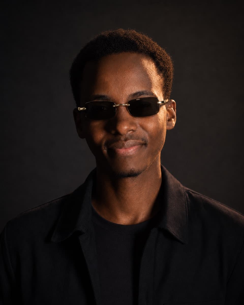 Lincoln Madaraka, photographed in warm light against a dark background.